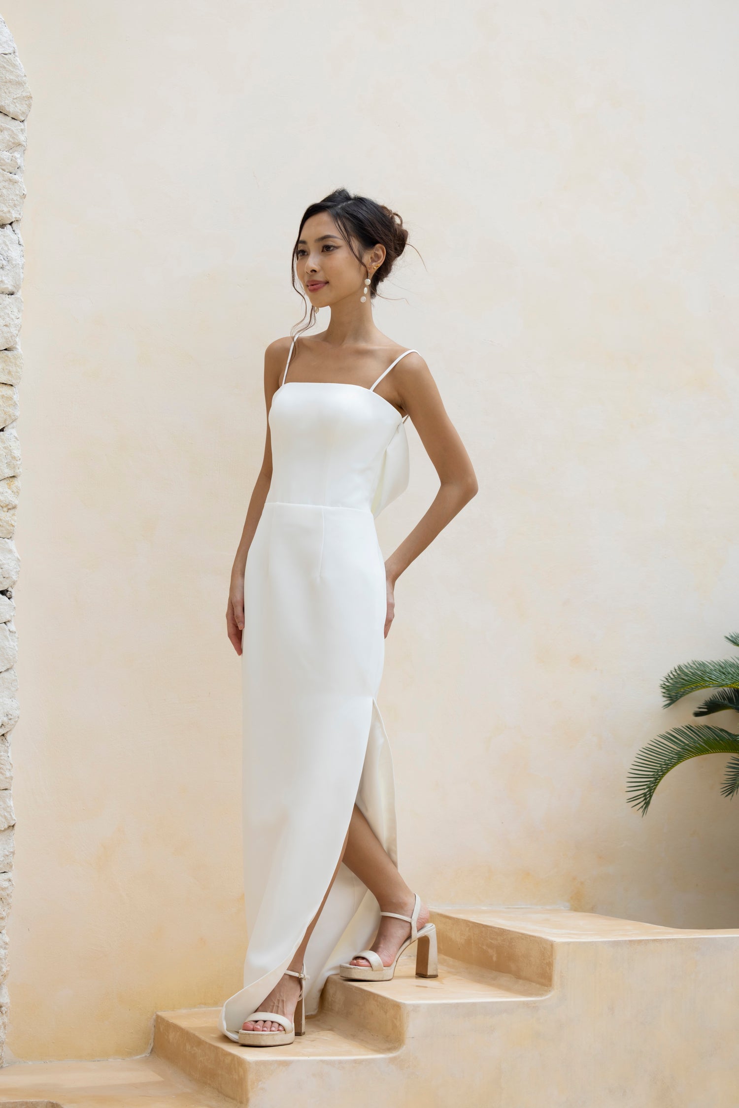 Bride in the Marley minimalist wedding gown with side slit and spaghetti straps by TheWolfandLily
