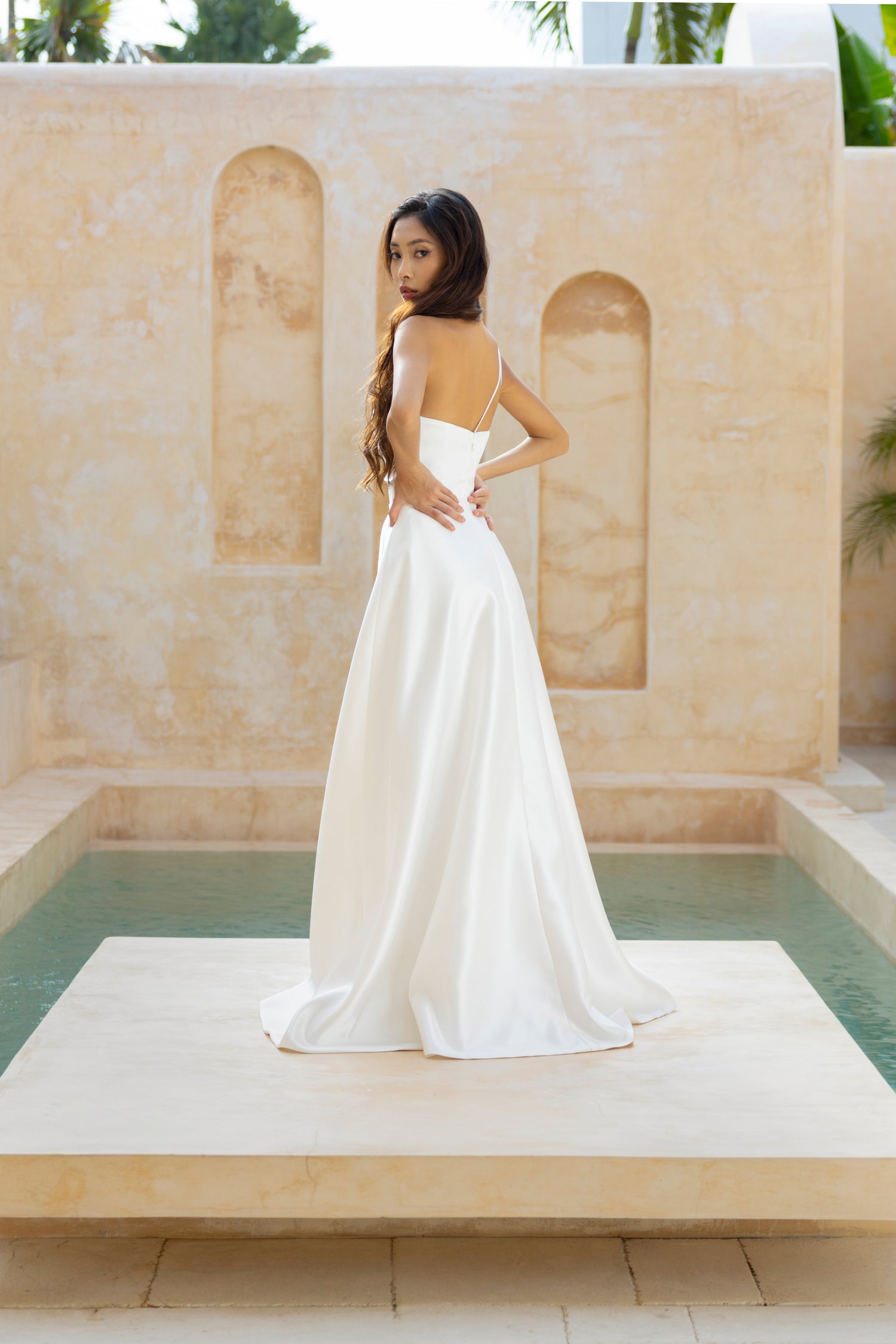 Back view of the Sloane gown by TheWolfandLily featuring a double toga strap and flowing A-line skirt