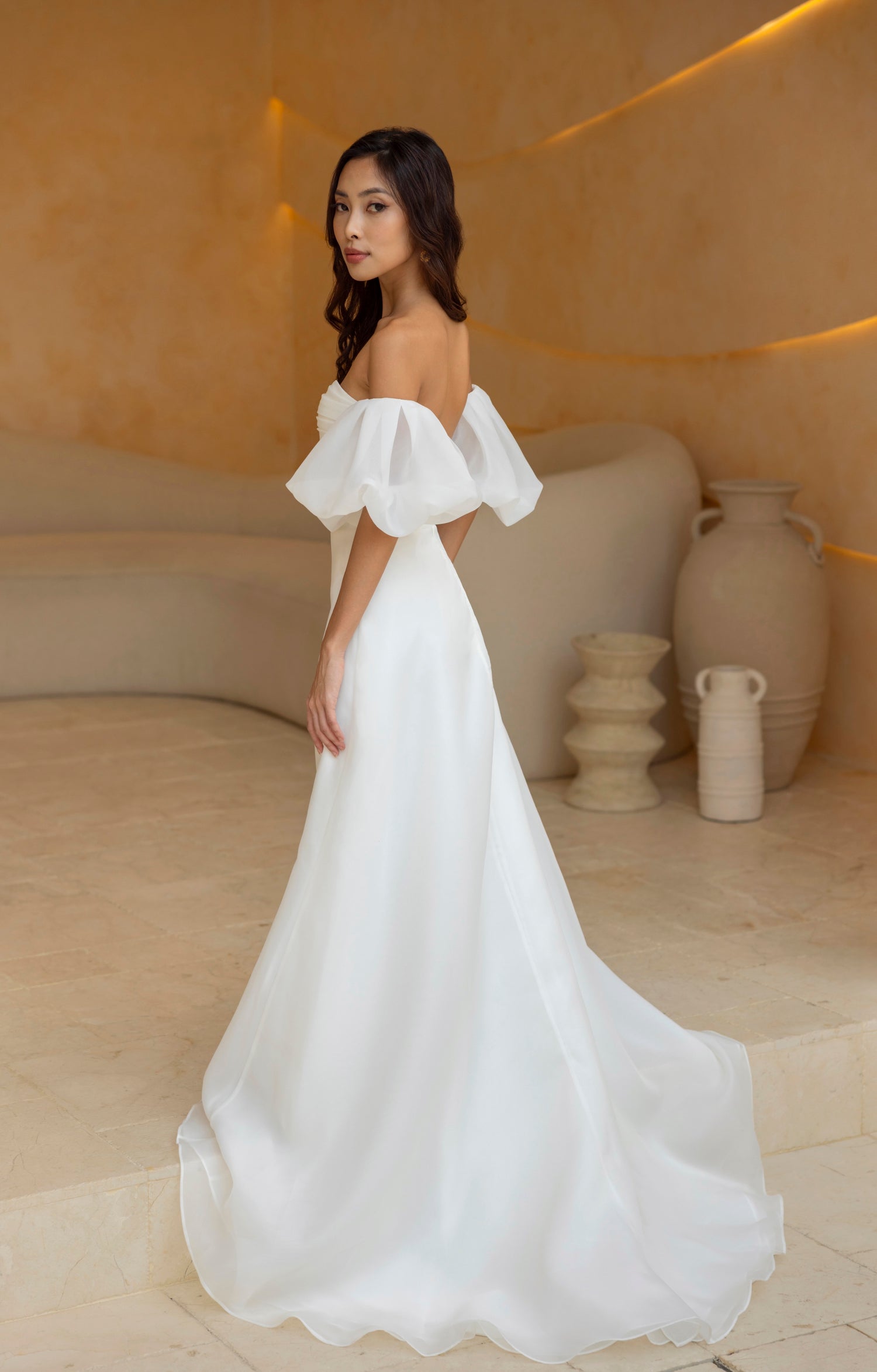 Back view of the Charlie gown with voluminous puff sleeves and soft A-line silhouette