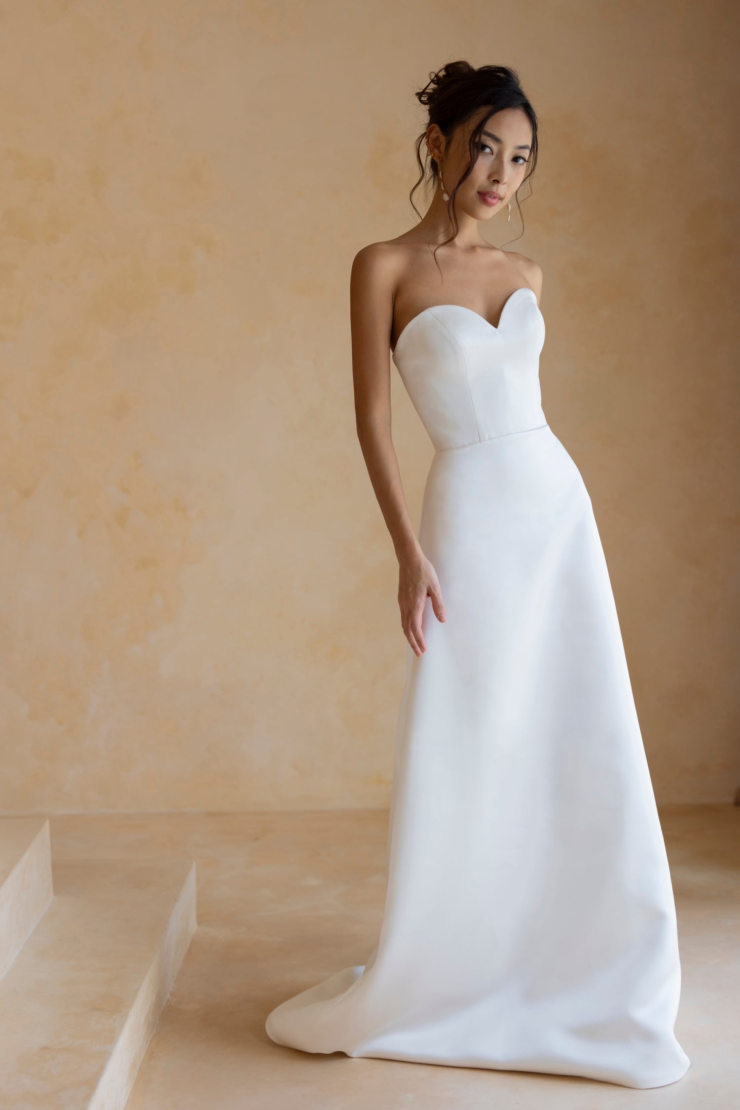 Close-up of Hally wedding gown with structured satin bodice and sweetheart neckline by TheWolfandLily