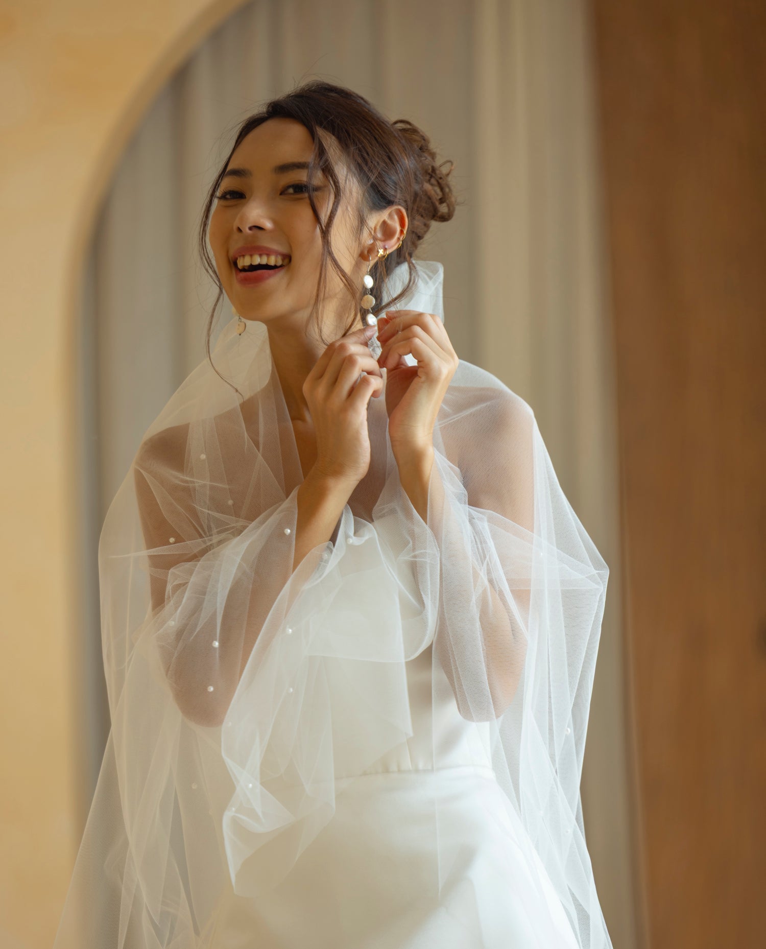 Elevate your bridal look with the Hally dress and our pearl veil. A modern pairing for brides who love soft structure, clean lines, and subtle romance.