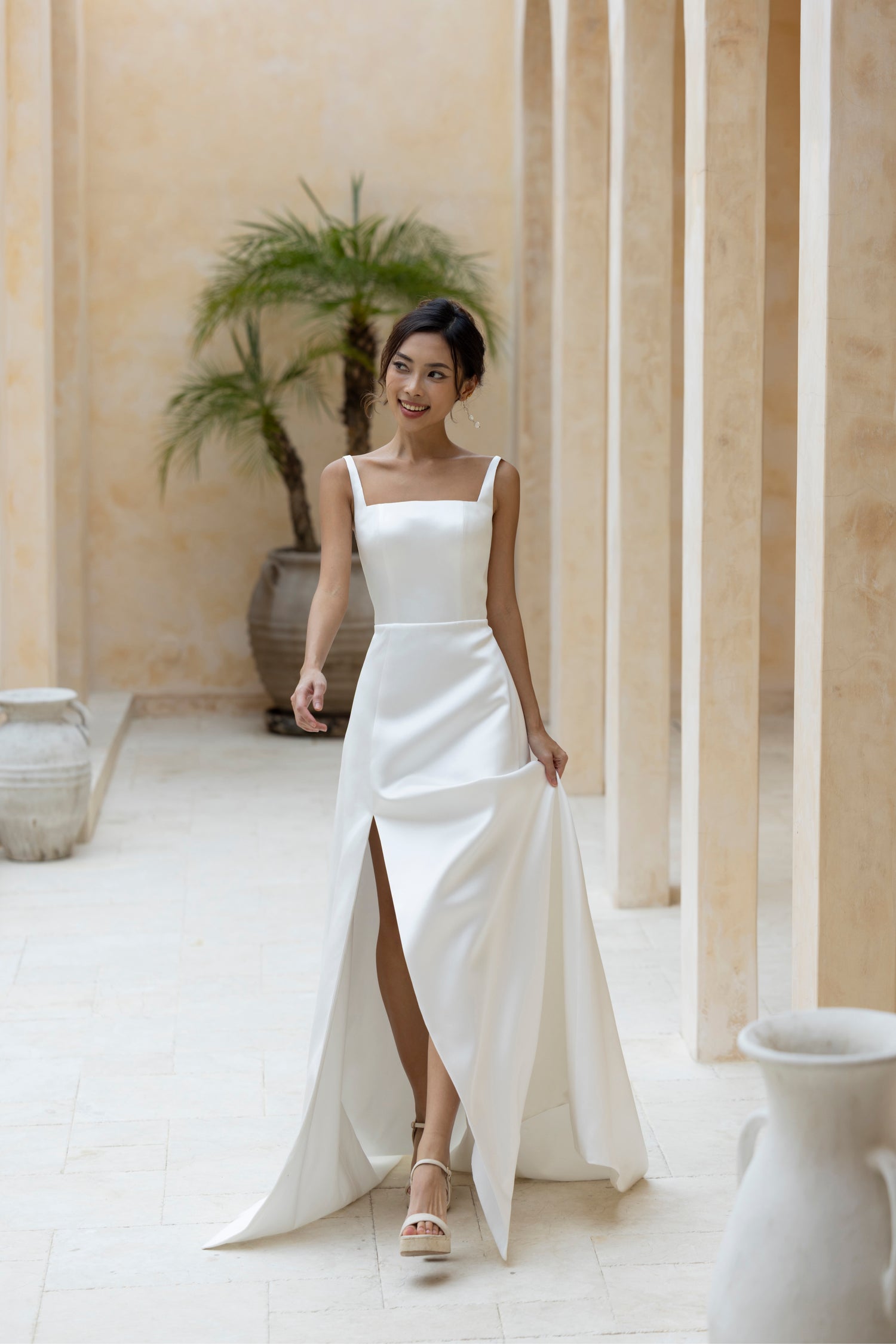 Elegant bridal gown with clean square neckline and high slit in ivory satin by TheWolfandLily