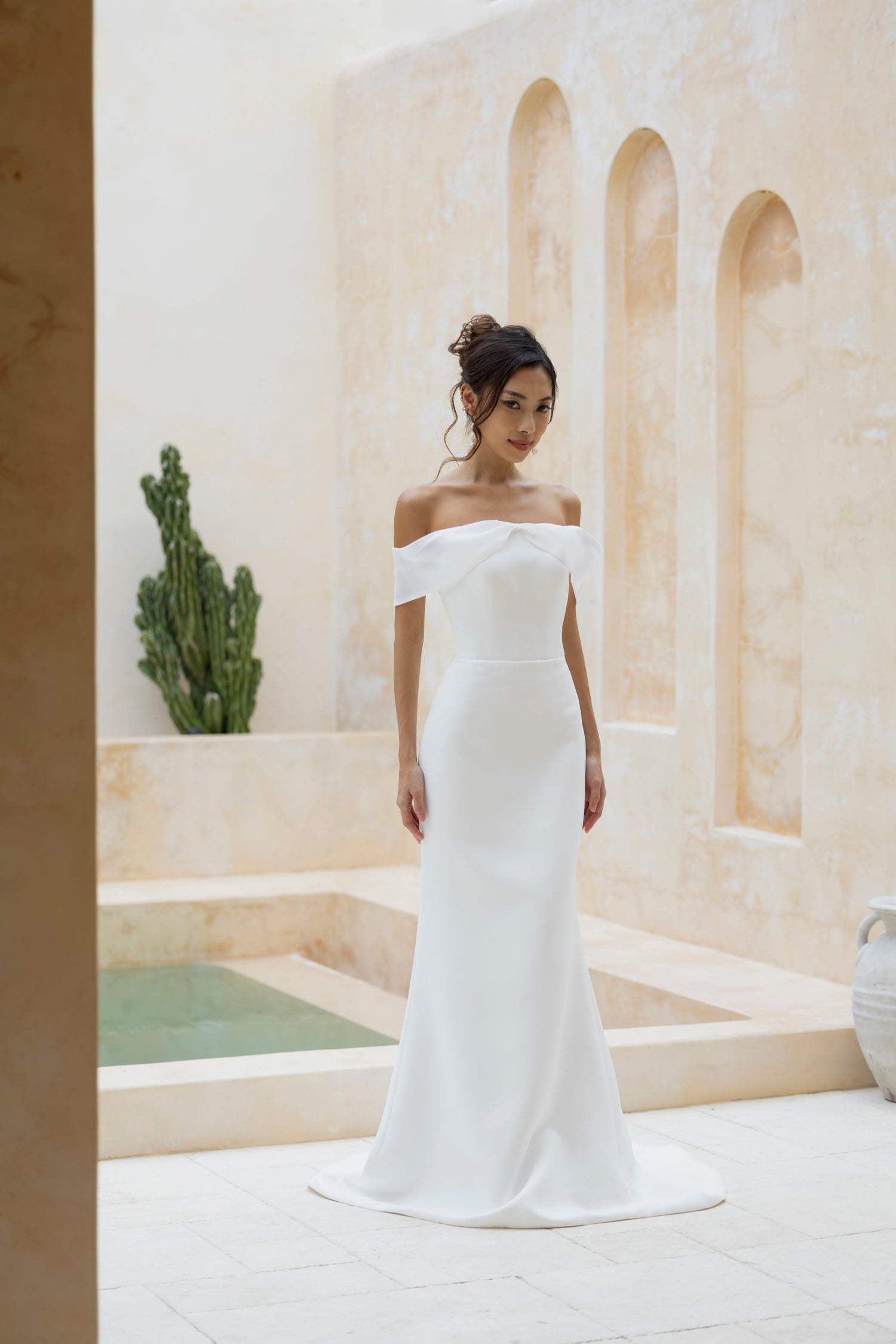 Bride wearing Robin dress by TheWolfandLily, minimalist design with organza bow off-shoulder band