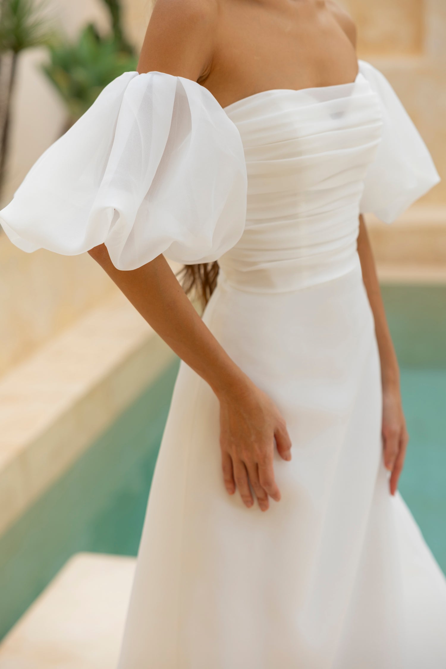 Close-up of the Charlie wedding dress with ruched bodice and organza puff sleeves by The Wolf and Lily